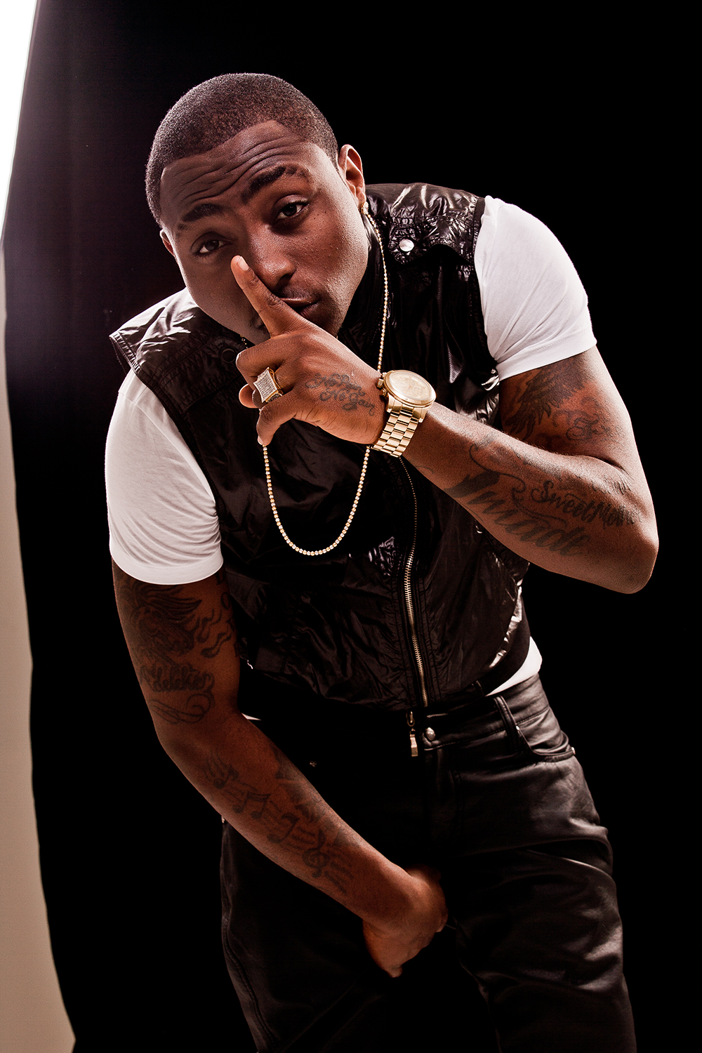 A man with tattoos posing for a picture. A man with tattoos posing for a picture.