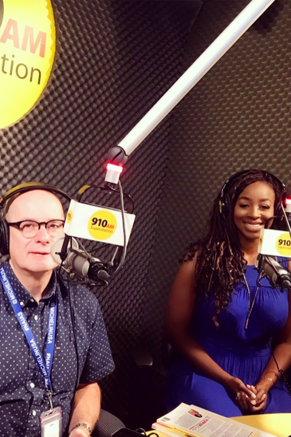 Two people sitting in front of a microphone in a radio studio. Two people sitting in front of a microphone in a radio studio.