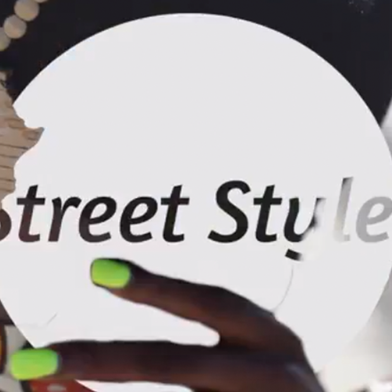 A woman is holding up a sign that says street style. A woman is holding up a sign that says street style.