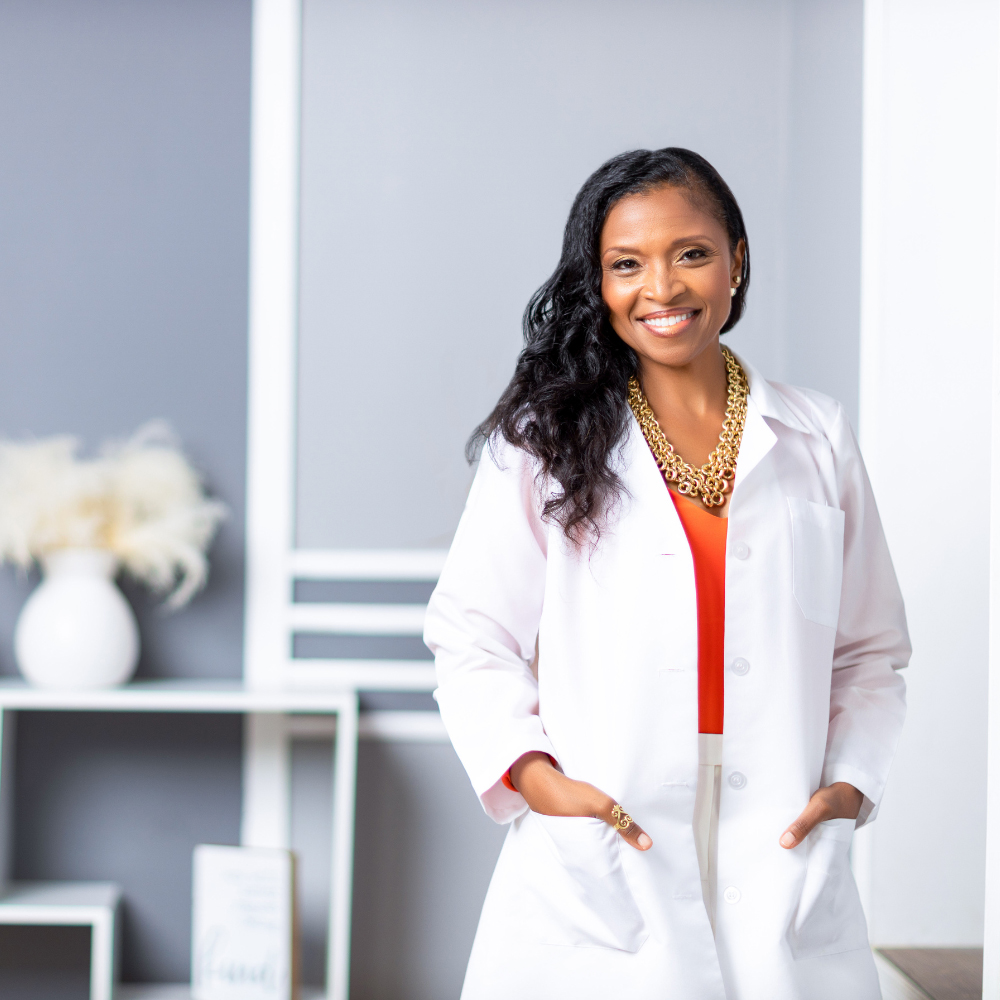 A woman in a lab coat standing in a room.